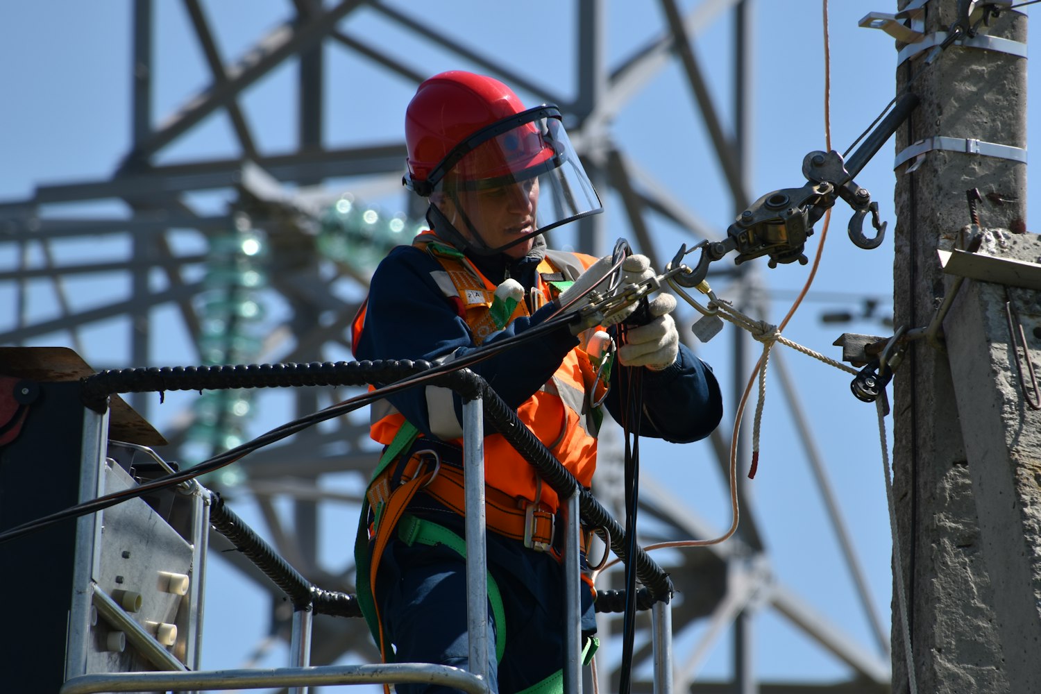 Electrician working at height on overhead lines