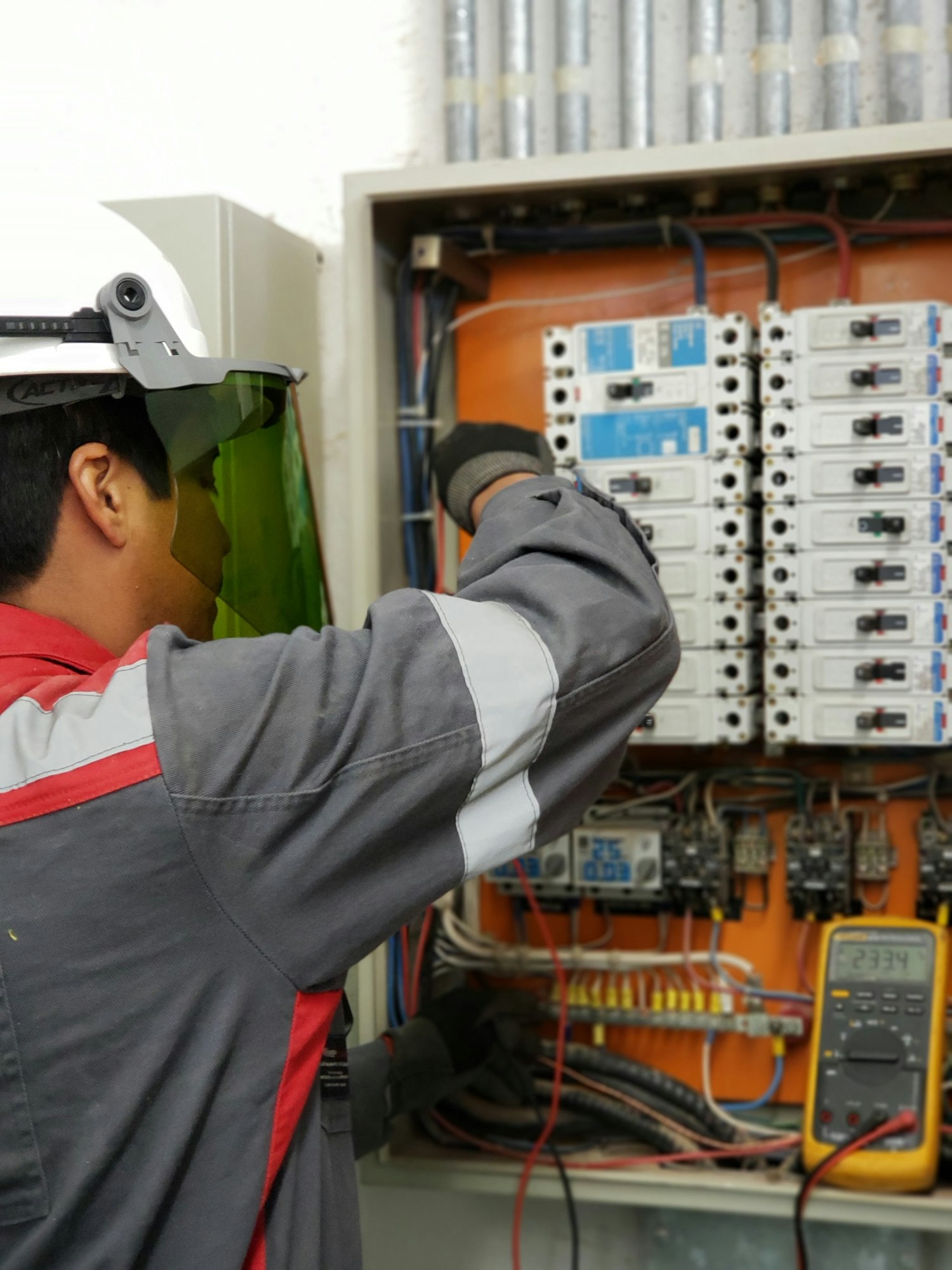 Electrician testing an electrical panel