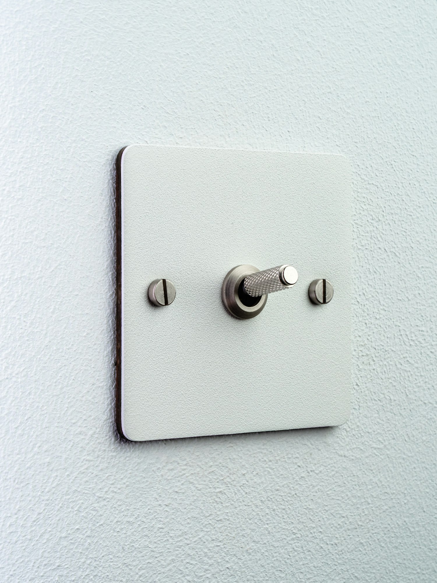 White light switch on a wall